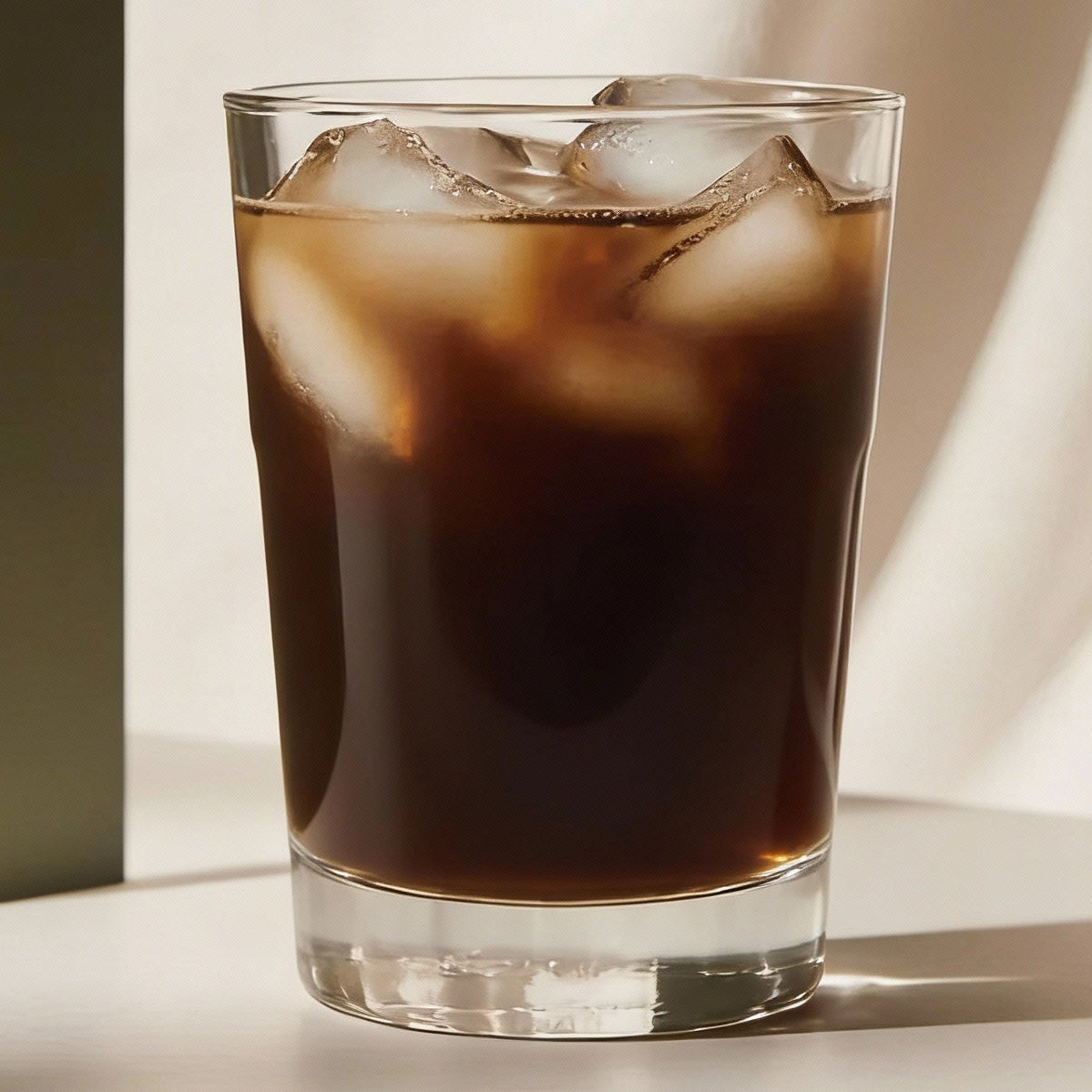 Glass of cold brew coffee with a neutral background