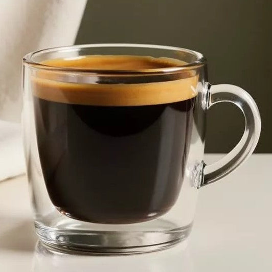 Glass mug with a red eye drink with a neutral background